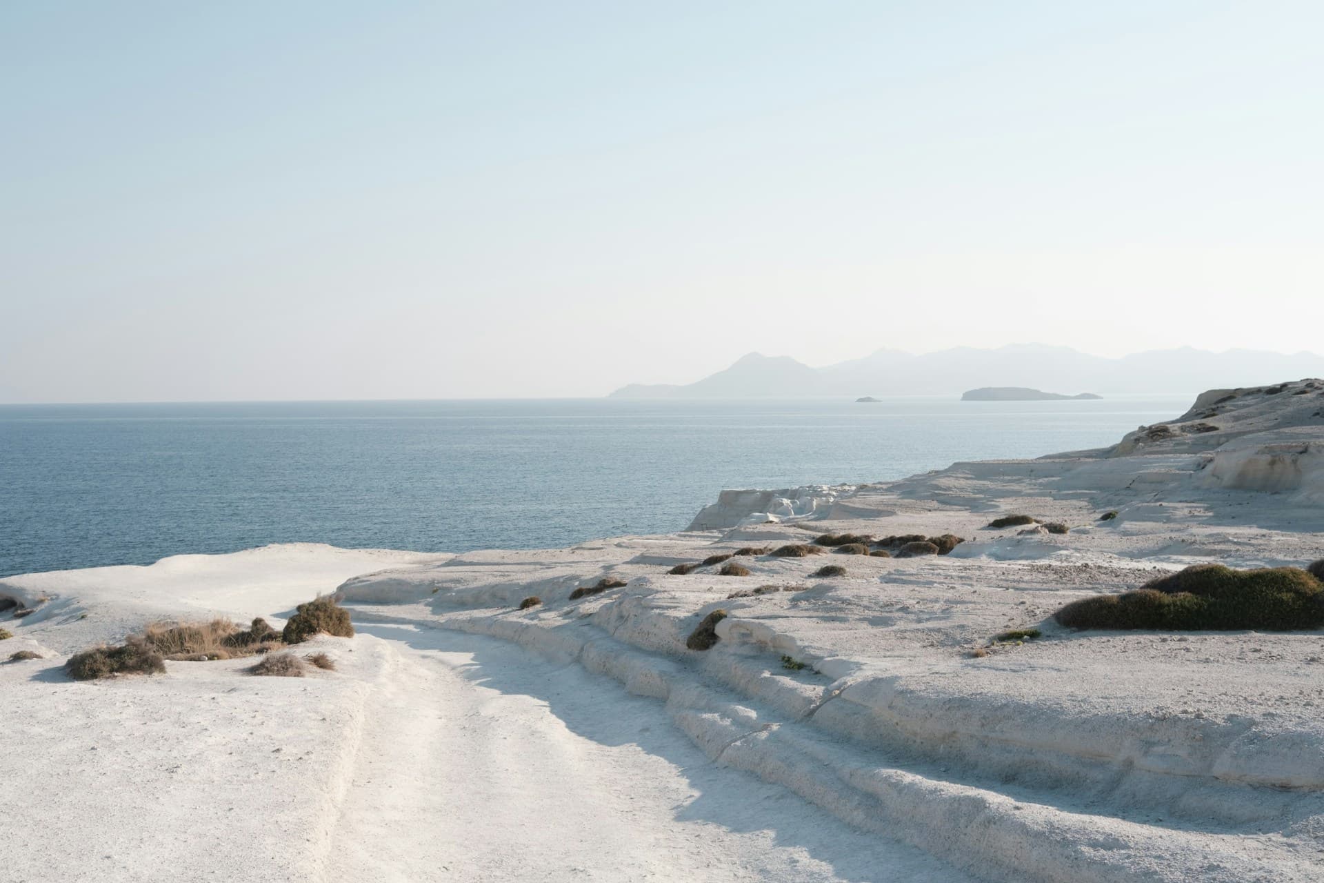 White volcanic rock formations of Sarakiniko meeting the blue Aegean, Milos
